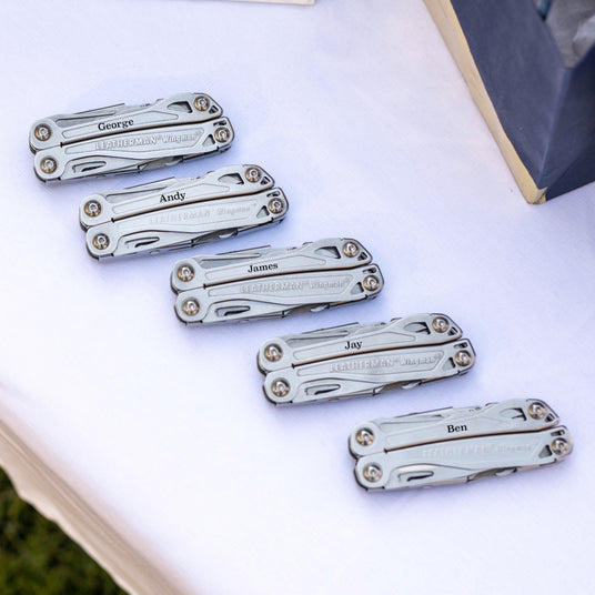 Translation missing: es.Five customized Leatherman Wingman closed laying on a table