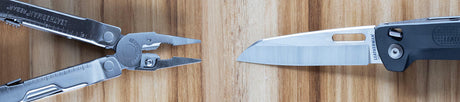 Translation missing: es.Stainless steel Leatherman Rebar® multi-tool and Leatherman FREE® knife on a wooden surface