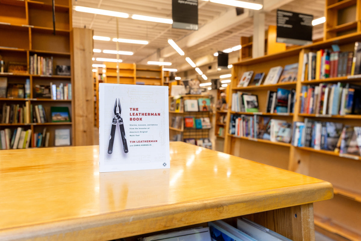 A copy of the Leatherman Book set upright on a wooden table in a bookstore