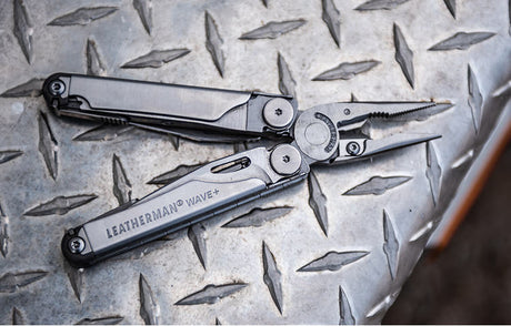 Translation missing: en.Stainless Steel Leatherman Wave+ multi-tool displayed on a metal surface, showcasing its pliers and sleek design