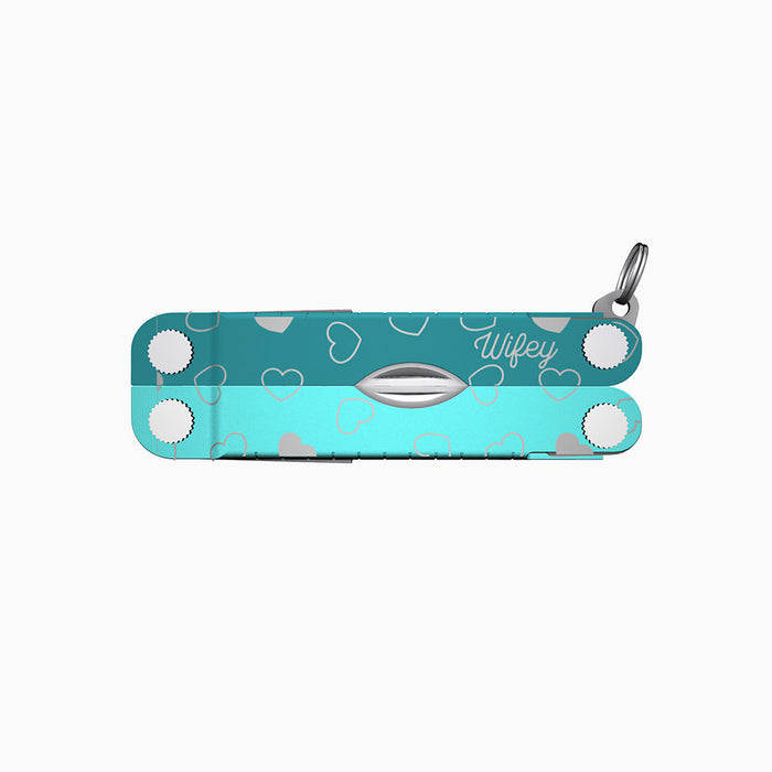 Translation missing: es.A two-tone turquoise Leatherman Micra multitool featuring heart engravings and the word “Wifey” engraved in a script font