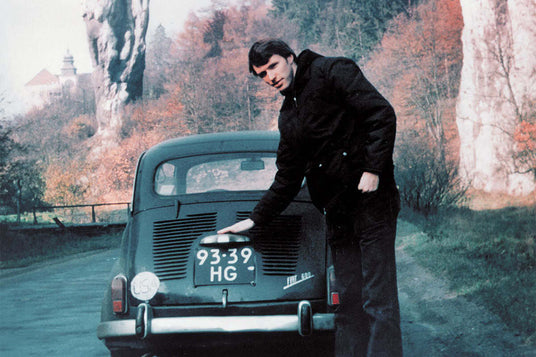 Translation missing: en.Tim Leatherman next to the fiat he toured Europe in